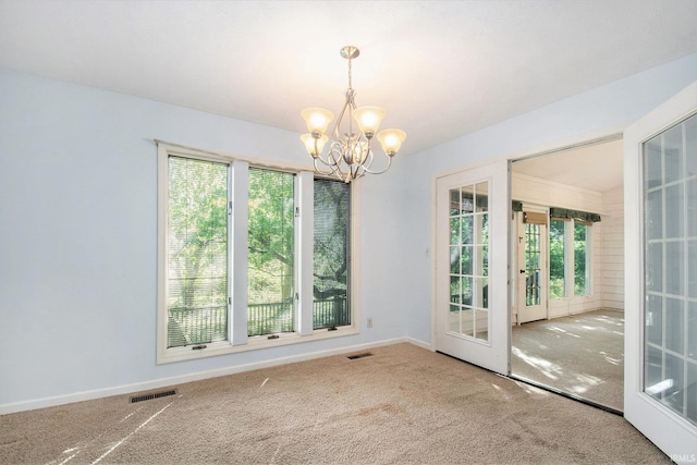 interior space featuring french doors, visible vents, plenty of natural light, and an inviting chandelier