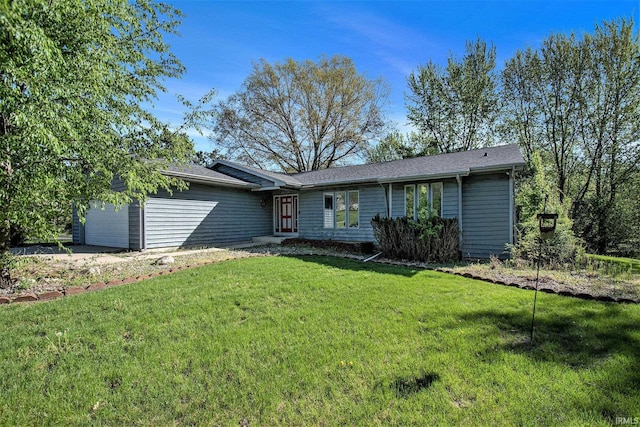 ranch-style house featuring a garage and a front lawn