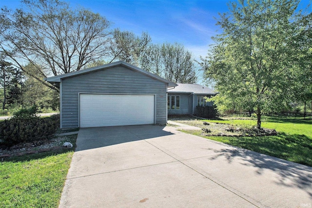 ranch-style home featuring a garage, driveway, and a front lawn