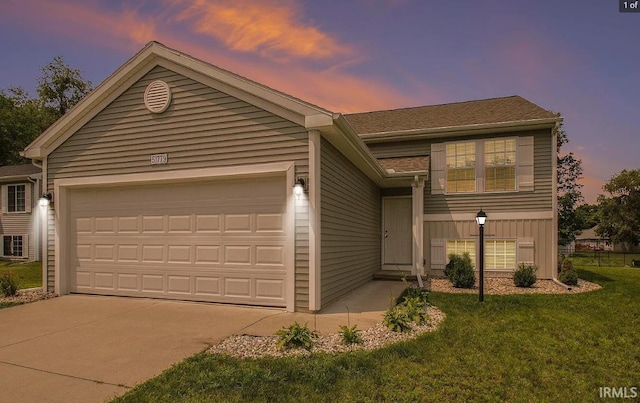 view of front of home with concrete driveway, a front lawn, and a garage