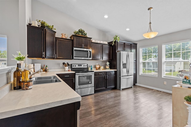 51779 Hannigan Dr, South Bend, IN 46637 - kitchen featuring appliances with stainless steel finishes, a sink, light countertops, dark brown cabinets, and recessed lighting