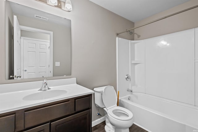 51779 Hannigan Dr, South Bend, IN 46637 - full bathroom with toilet, vanity, bathtub / shower combination, wood finished floors, and baseboards