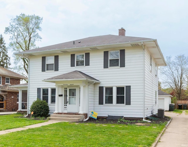 1719 Wilber St, South Bend, IN 46628 - colonial inspired home featuring a chimney, cooling unit, and a front lawn