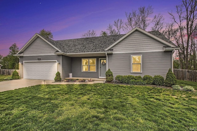 ranch-style home with a garage, fence, a shingled roof, concrete driveway, and a yard
