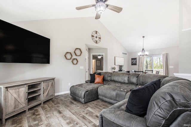 living area featuring visible vents, wood finished floors, high vaulted ceiling, baseboards, and ceiling fan with notable chandelier