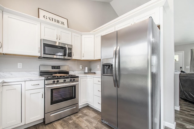 kitchen with stainless steel appliances, wood finished floors, and white cabinetry