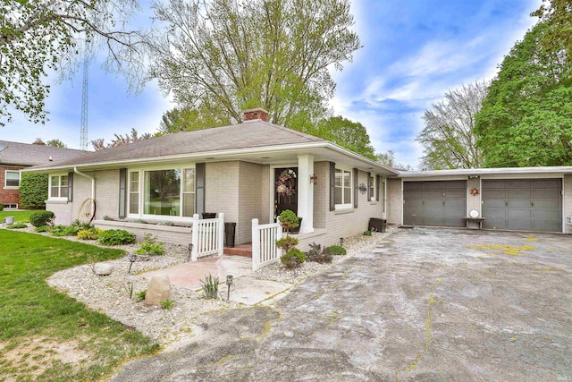 ranch-style house with an attached garage, a front lawn, aphalt driveway, brick siding, and a chimney