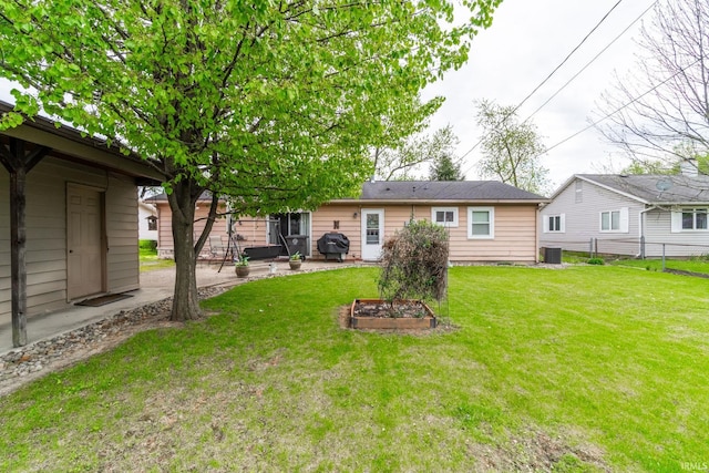 back of house featuring a patio area, central air condition unit, a yard, and fence