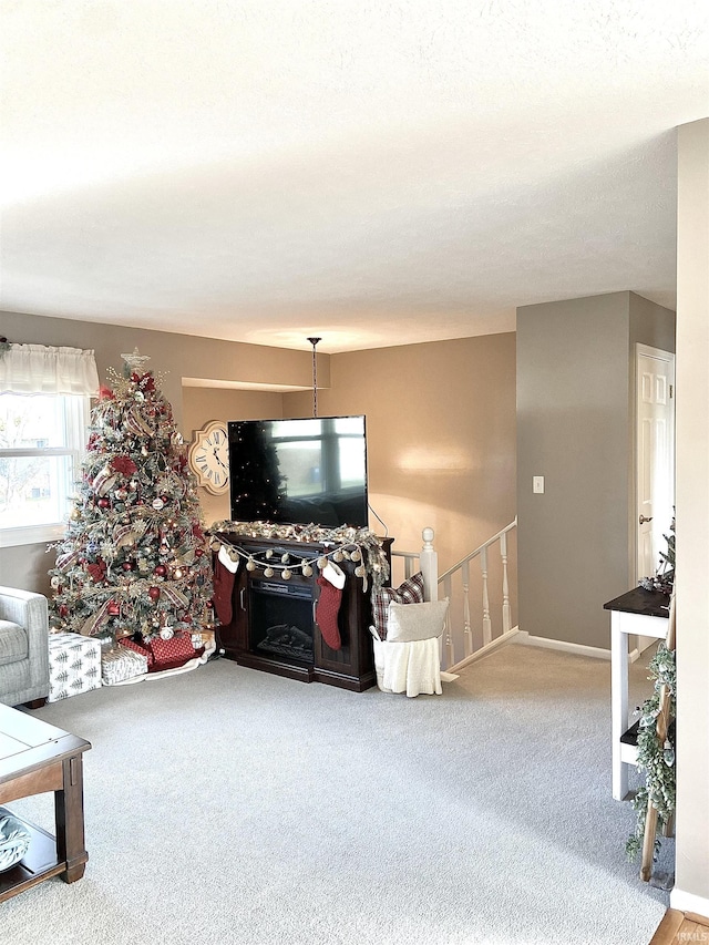 living room featuring carpet flooring and baseboards