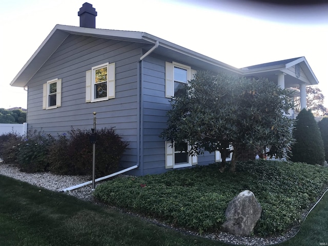 view of side of home with a chimney