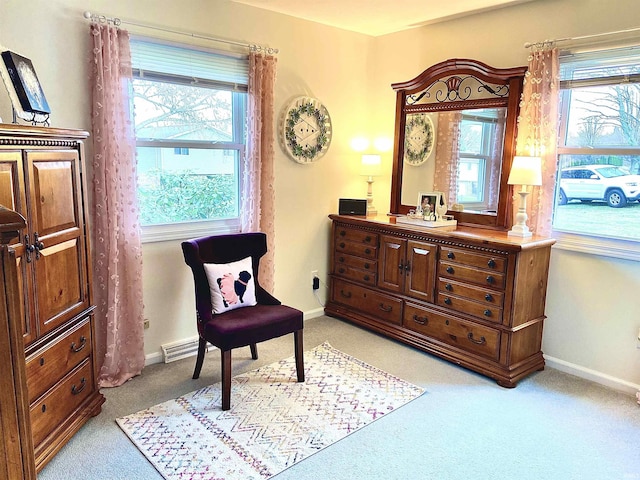 sitting room featuring baseboards, a wealth of natural light, and light carpet