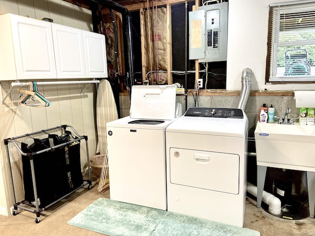 laundry area featuring a sink, cabinet space, electric panel, and washing machine and clothes dryer