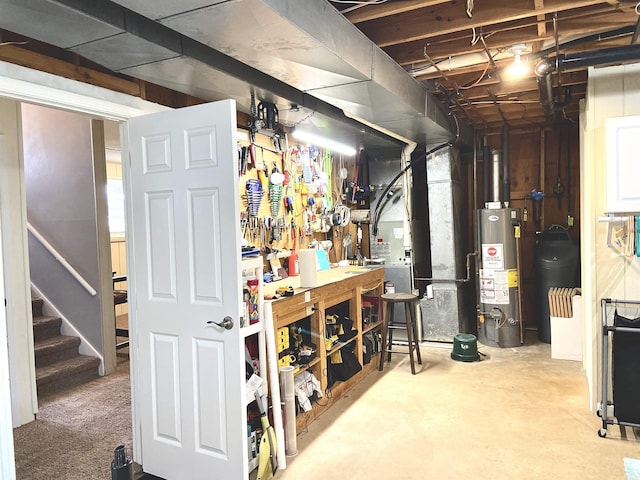unfinished basement featuring a workshop area, stairway, and gas water heater