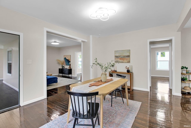 dining area with baseboards and hardwood / wood-style flooring