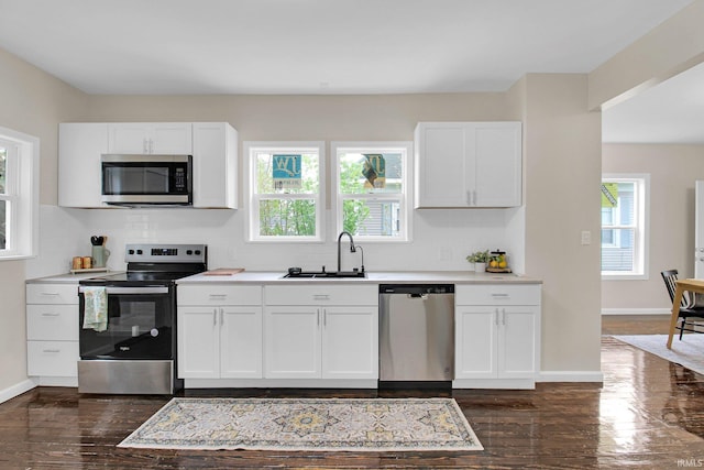 kitchen featuring a sink, white cabinets, tasteful backsplash, and stainless steel appliances