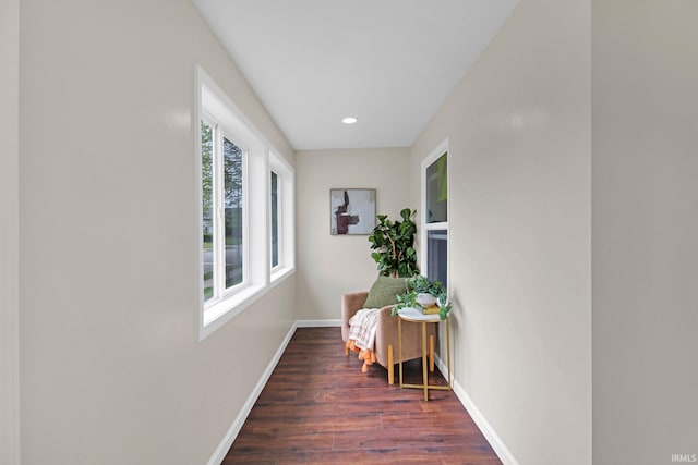 hall featuring baseboards, recessed lighting, and dark wood-type flooring