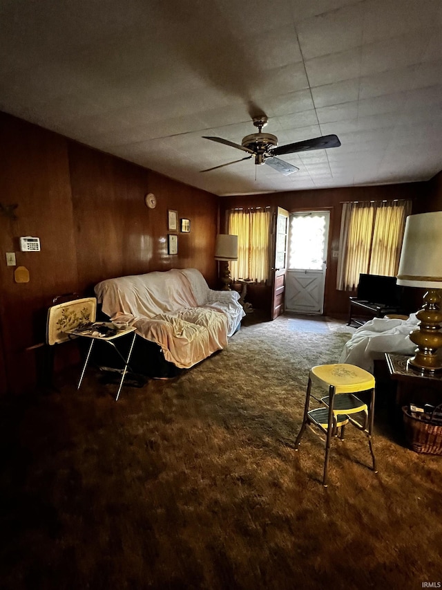 607 Troy Rd, Washington, IN 47501 - living room with ceiling fan, carpet flooring, and wood walls