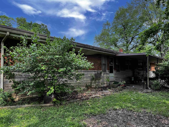view of side of property featuring brick siding
