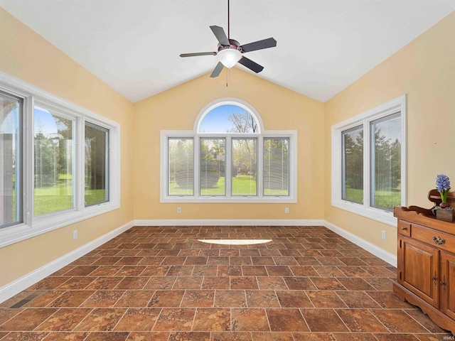 unfurnished room with baseboards, ceiling fan, and vaulted ceiling