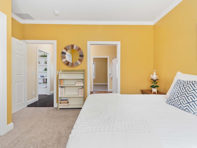 carpeted bedroom featuring baseboards and ornamental molding