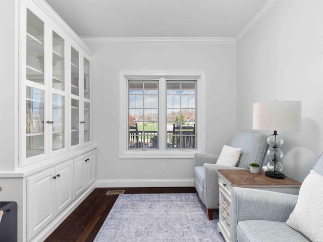 sitting room featuring crown molding, dark wood-style flooring, baseboards, and visible vents