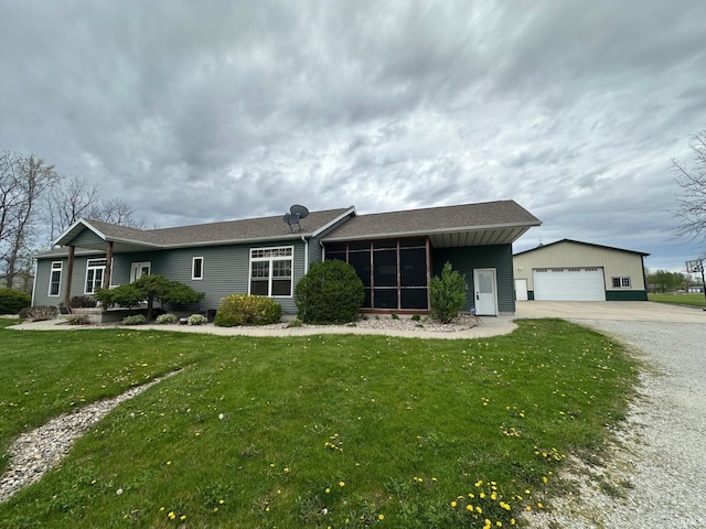 8679 E 850th St, New Carlisle, IN 46552 - single story home with a sunroom, a front lawn, an outbuilding, and a detached garage