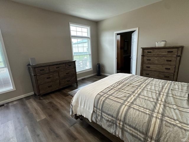 8679 E 850th St, New Carlisle, IN 46552 - bedroom with dark wood-style flooring, baseboards, and visible vents