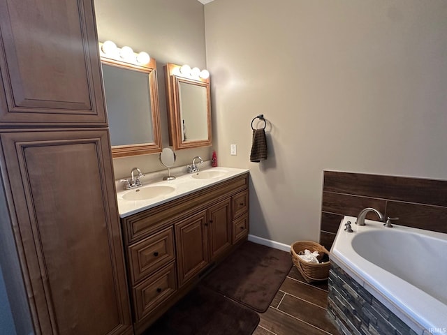 8679 E 850th St, New Carlisle, IN 46552 - full bathroom featuring double vanity, baseboards, a sink, and a garden tub