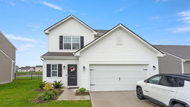 traditional-style home with a shingled roof, a front yard, and concrete driveway