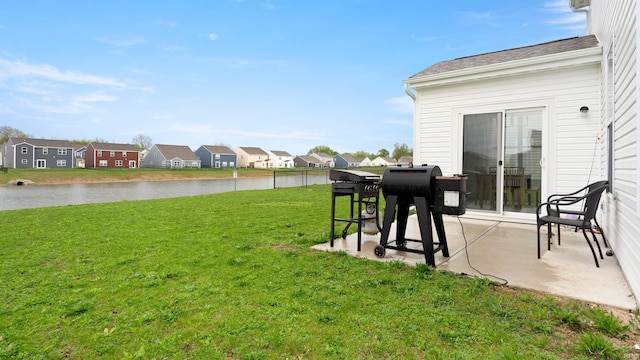 view of yard with a water view, a patio area, and a residential view
