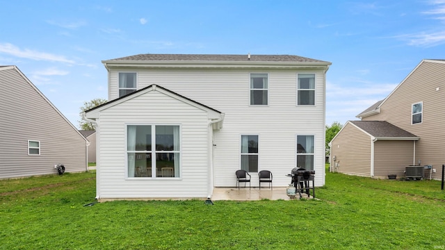 rear view of house featuring a yard, central AC unit, and a patio area