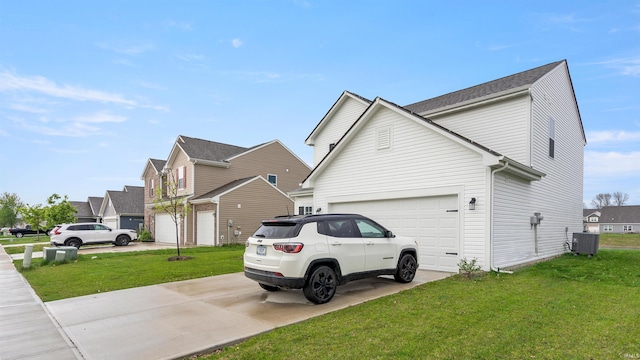 view of side of home with a yard, a residential view, central air condition unit, concrete driveway, and an attached garage