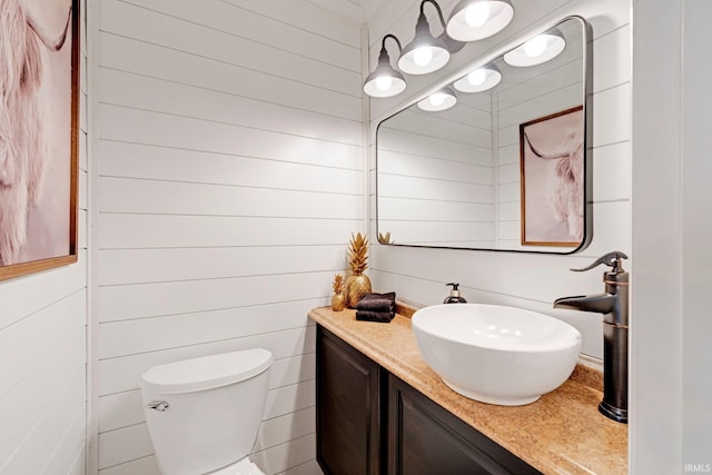 119 Southridge Dr, Fort Wayne, IN 46825 - half bathroom with vanity, wood walls, and toilet