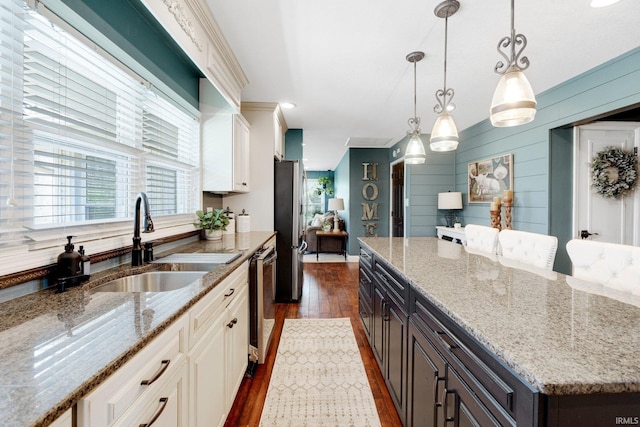 119 Southridge Dr, Fort Wayne, IN 46825 - kitchen with white cabinets, light stone countertops, appliances with stainless steel finishes, a sink, and dark wood-type flooring
