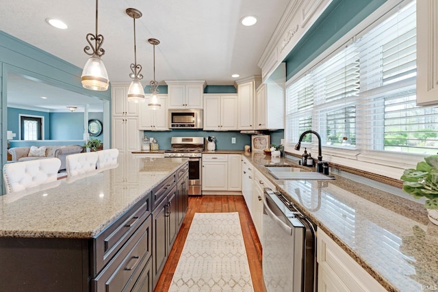 119 Southridge Dr, Fort Wayne, IN 46825 - kitchen featuring white cabinetry, a sink, stainless steel appliances, recessed lighting, and light wood-style flooring