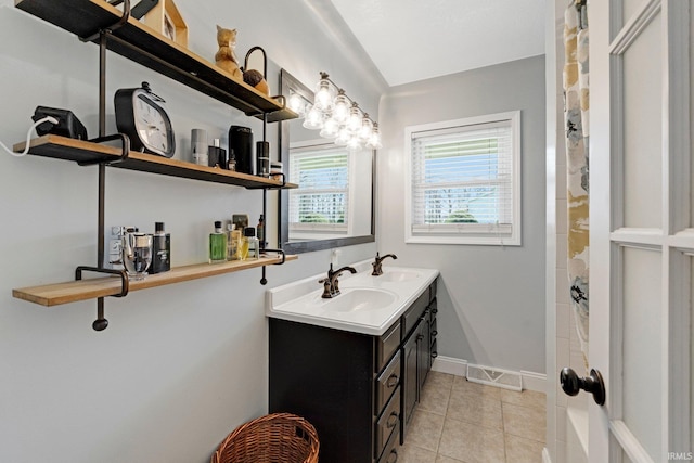 119 Southridge Dr, Fort Wayne, IN 46825 - bathroom featuring tile patterned flooring, a sink, baseboards, and double vanity