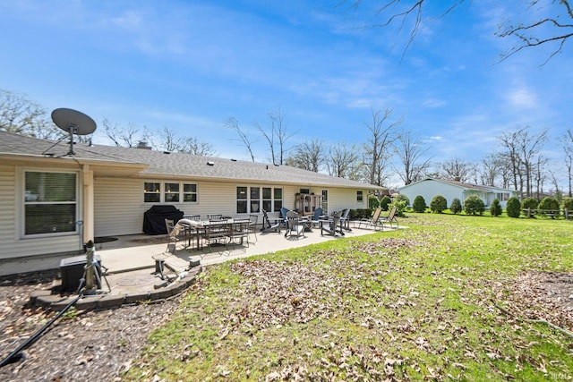 119 Southridge Dr, Fort Wayne, IN 46825 - rear view of house featuring a lawn, roof with shingles, and a patio area