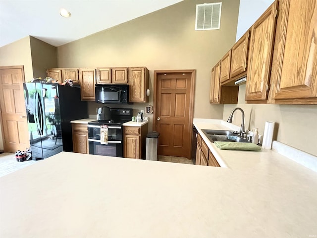 kitchen with a sink, light countertops, high vaulted ceiling, visible vents, and black appliances