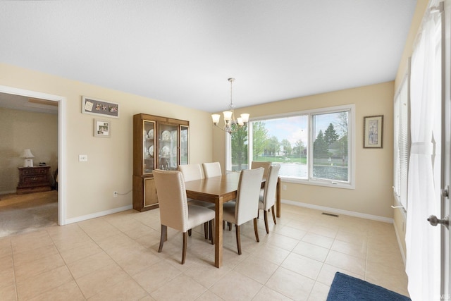 dining room with an inviting chandelier, baseboards, light tile patterned floors, and visible vents