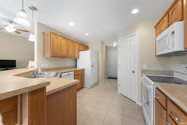kitchen featuring ceiling fan, hanging light fixtures, a sink, white appliances, and light countertops