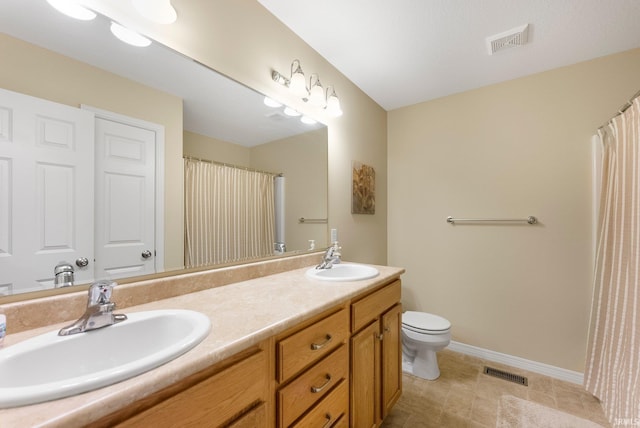bathroom featuring visible vents, a sink, and baseboards