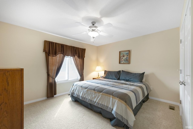 bedroom featuring carpet floors, a ceiling fan, baseboards, and visible vents