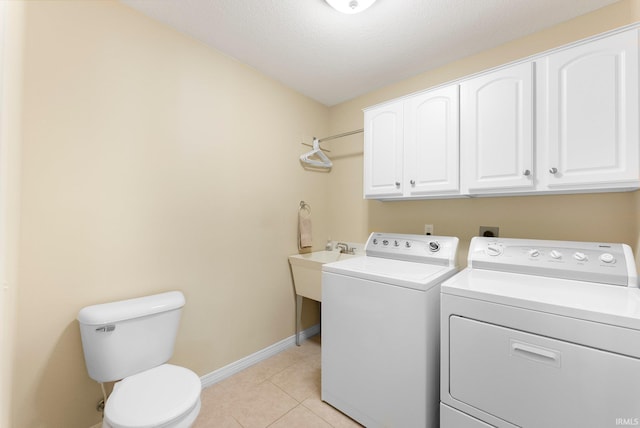 laundry room featuring laundry area, light tile patterned floors, baseboards, a sink, and separate washer and dryer