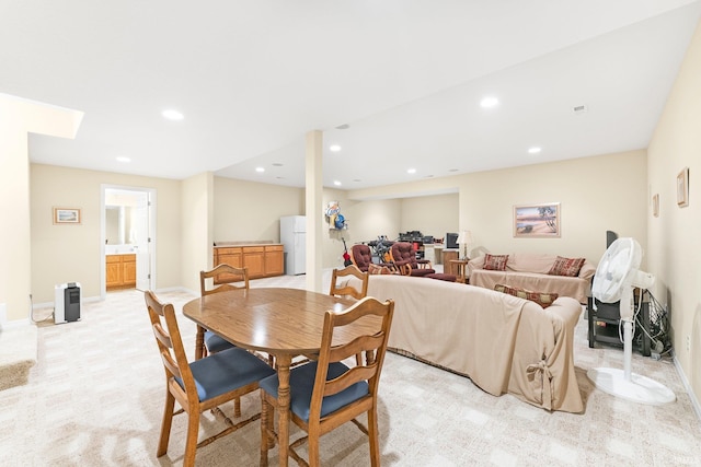 dining space with baseboards, light carpet, and recessed lighting