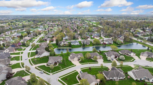 drone / aerial view featuring a water view and a residential view