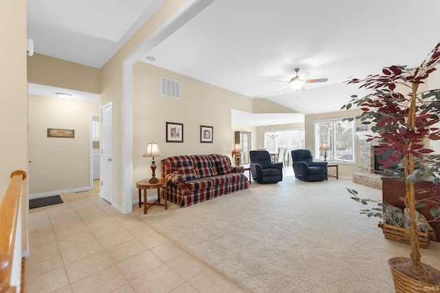 living area featuring visible vents, light carpet, ceiling fan, light tile patterned floors, and vaulted ceiling