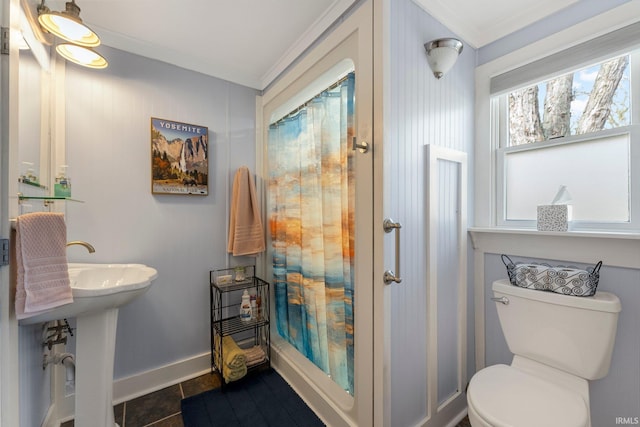 bathroom with baseboards, ornamental molding, curtained shower, and toilet
