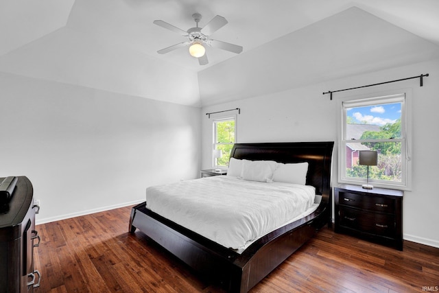 bedroom with baseboards, a ceiling fan, wood finished floors, and lofted ceiling