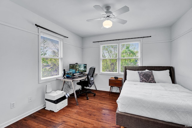 bedroom featuring baseboards, a ceiling fan, and wood finished floors