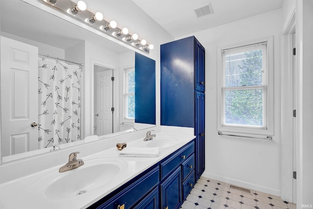 full bathroom with a sink, double vanity, and visible vents